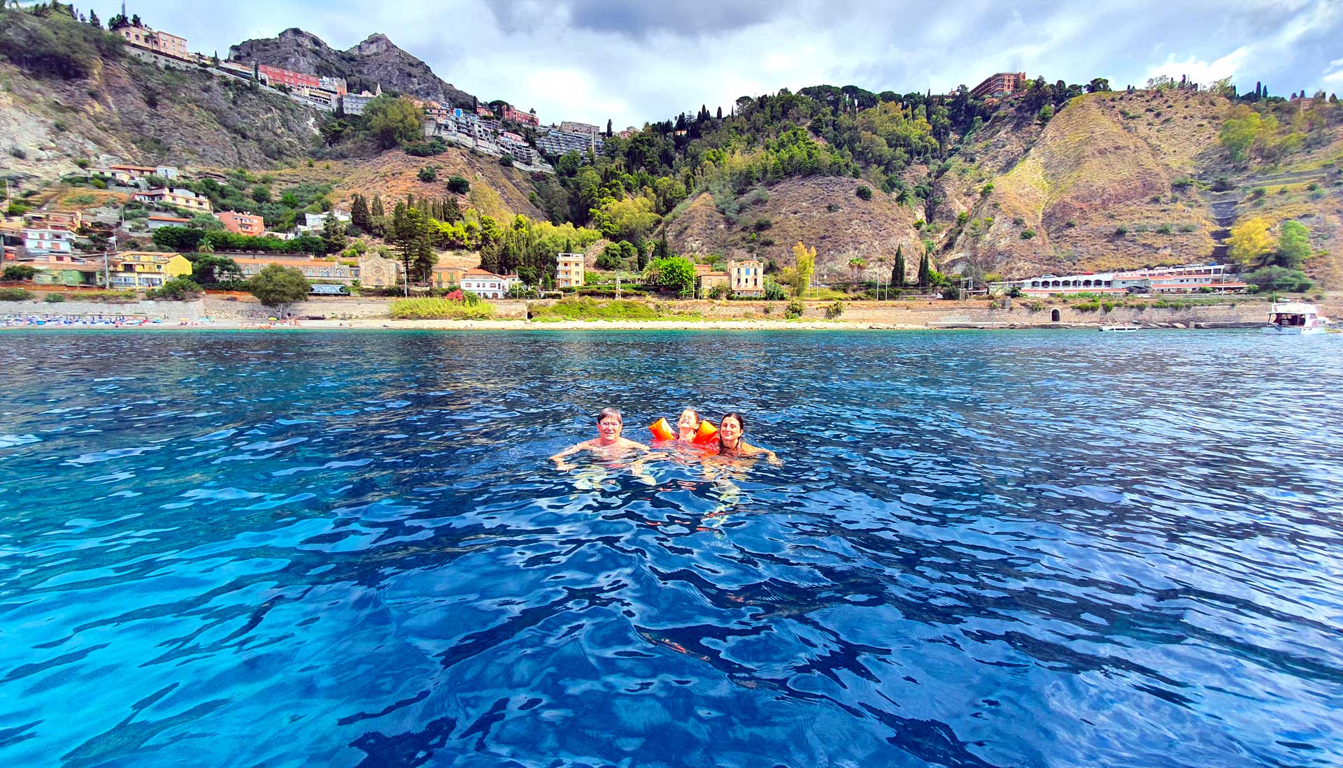 Family enjoying the private boat tour in Taormina