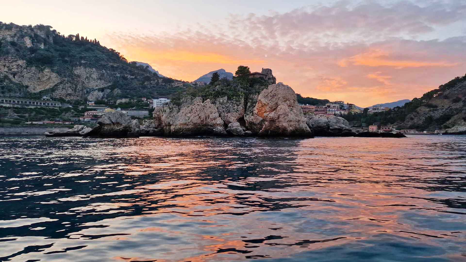 Cielo che si tinge di arancione e rosa su Taormina al tramonto
