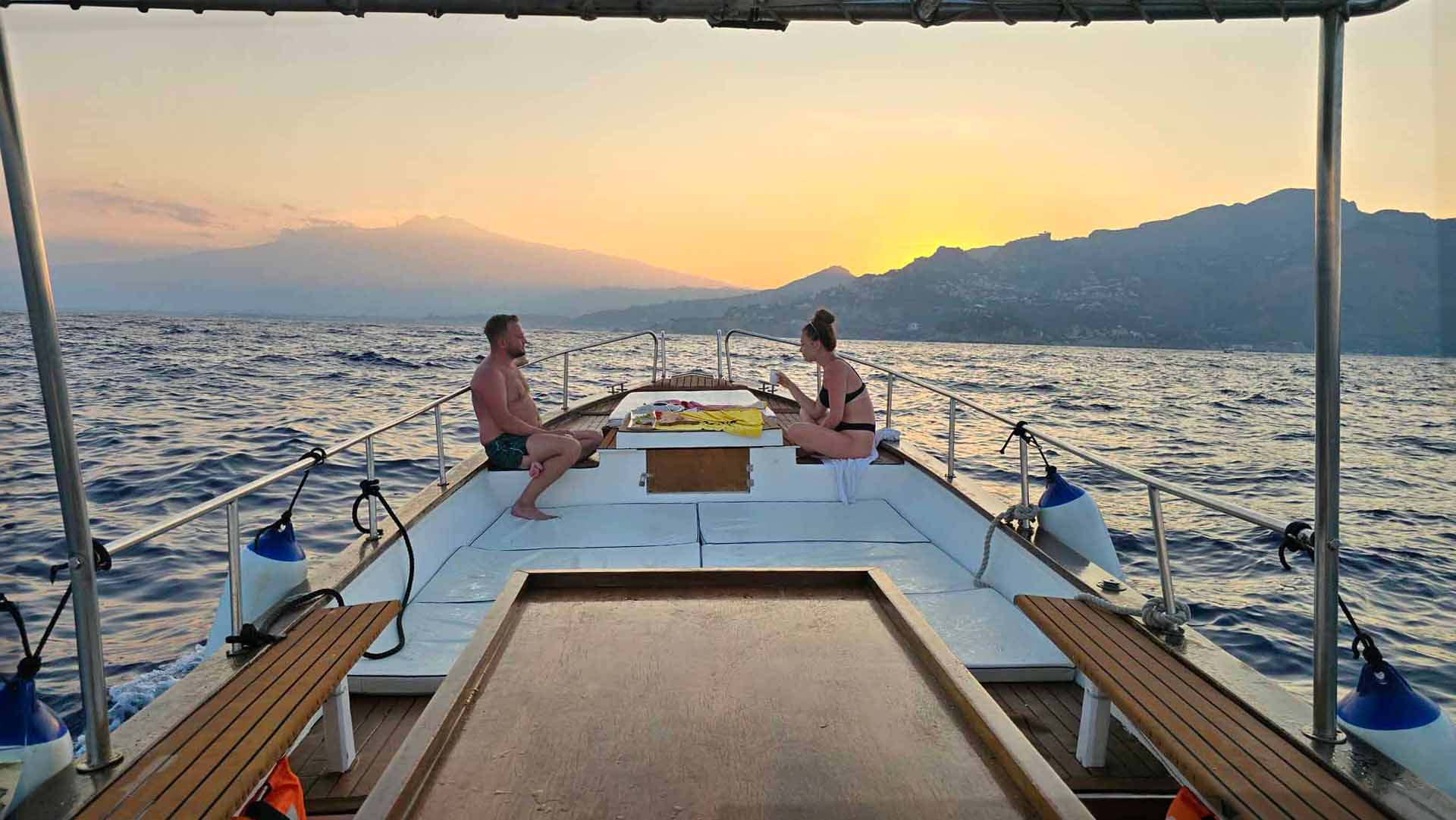 Couple enjoying the sunset on a private Taormina boat tour