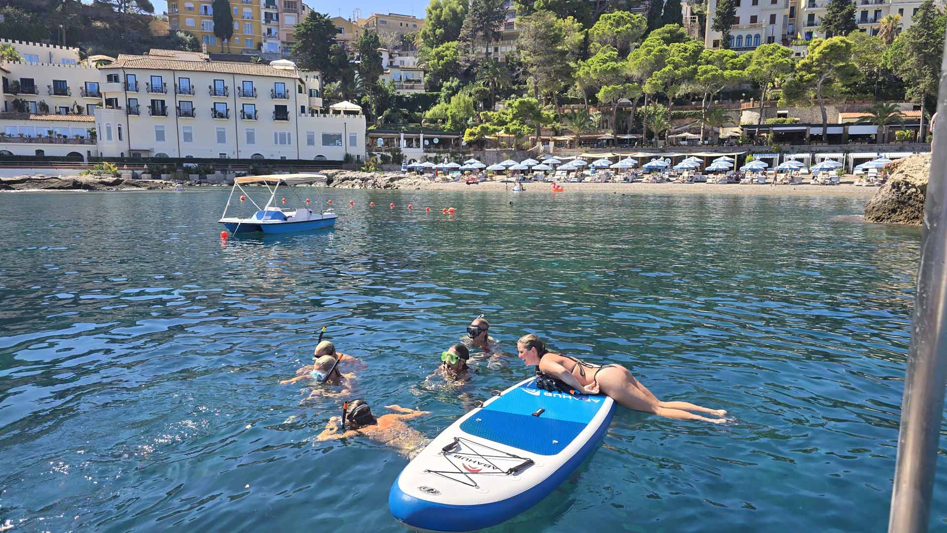 Crystal-clear water of a hidden Taormina bay